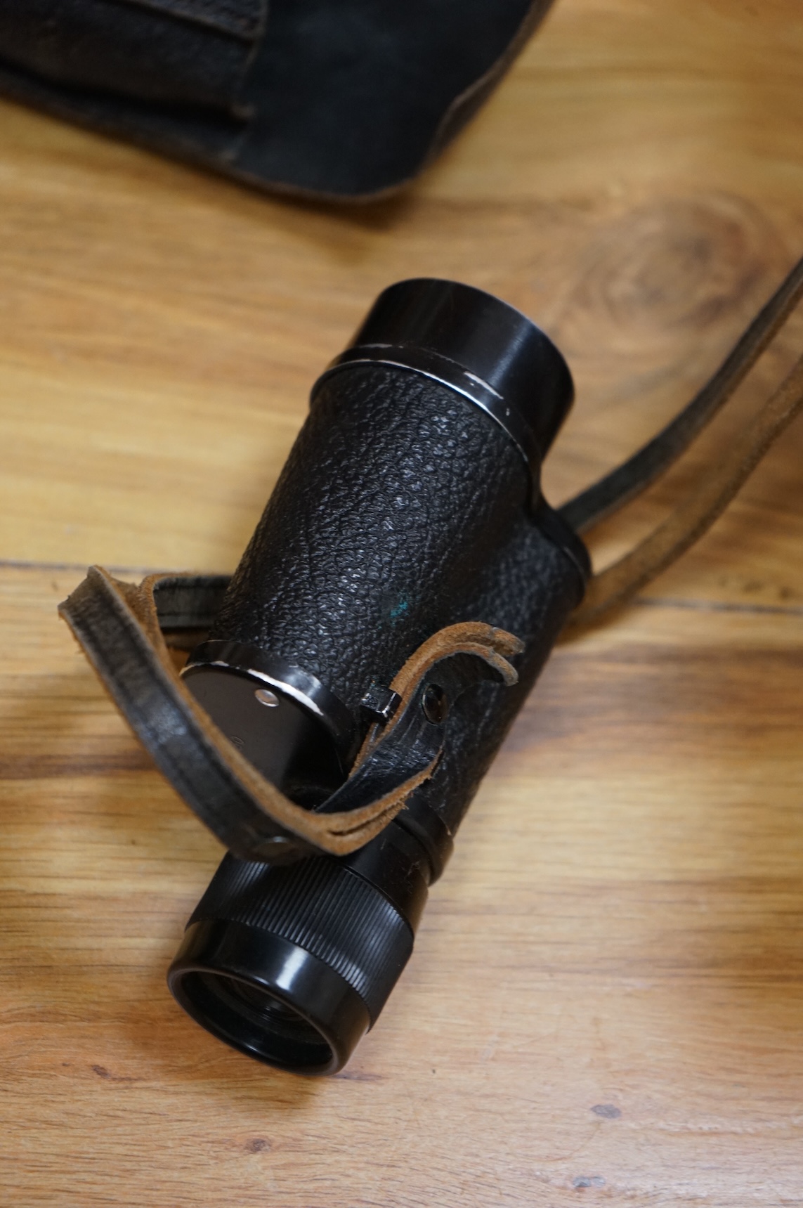 A Sykes-Fairburn Fighting Knife by Wilkinson sword in its leather scabbard, together with a 1942 Mk.III military compass by T.G.Co.Ltd. in a webbing pouch dated 1940, together with another compass, a telescope in a leath